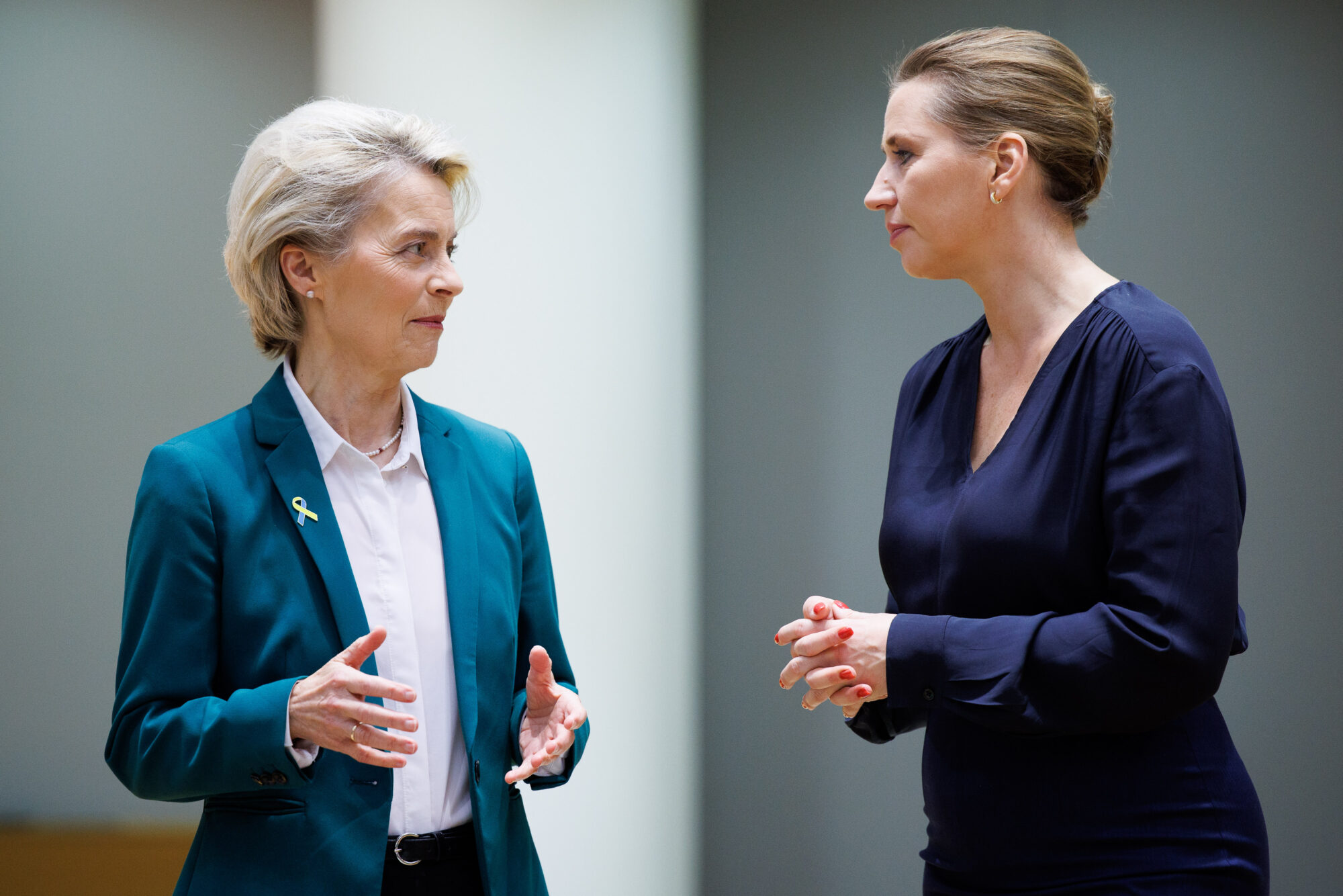 Ursula von der Leyen and Mette Frederiksen face each other in conversation at a European Council meeting in Brussels